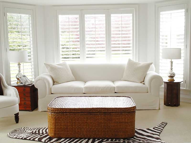 bright lounge with long white shutters at windows